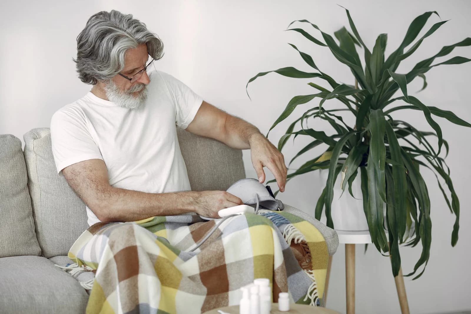 A man preparing a blood pressure monitor at home
