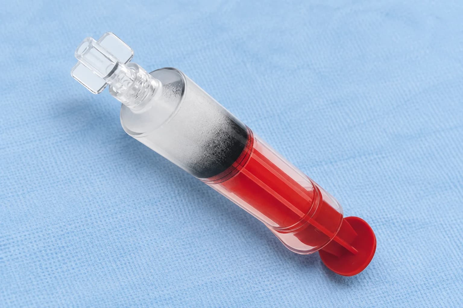 Illustration of a capped embolization microsphere syringe