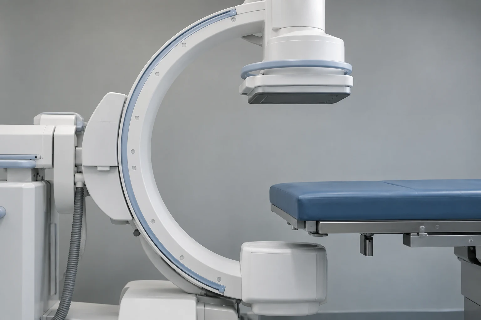 Illustrative fluoroscopy equipment beside a procedure table