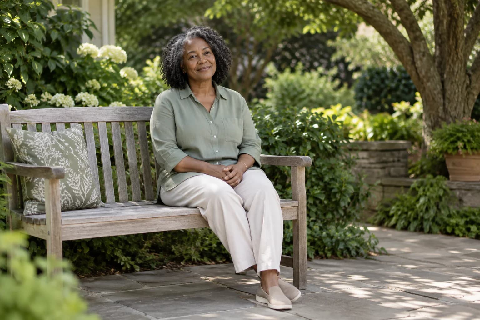 A woman seated on a garden bench