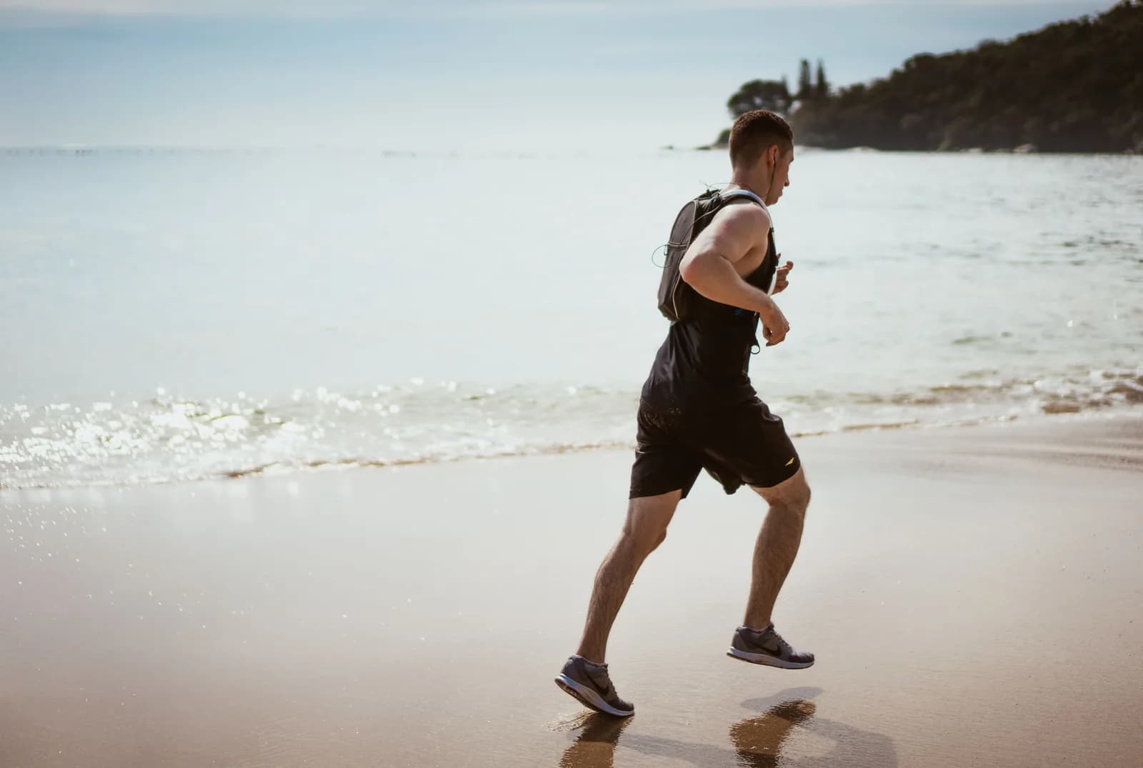 A man running along the shoreline