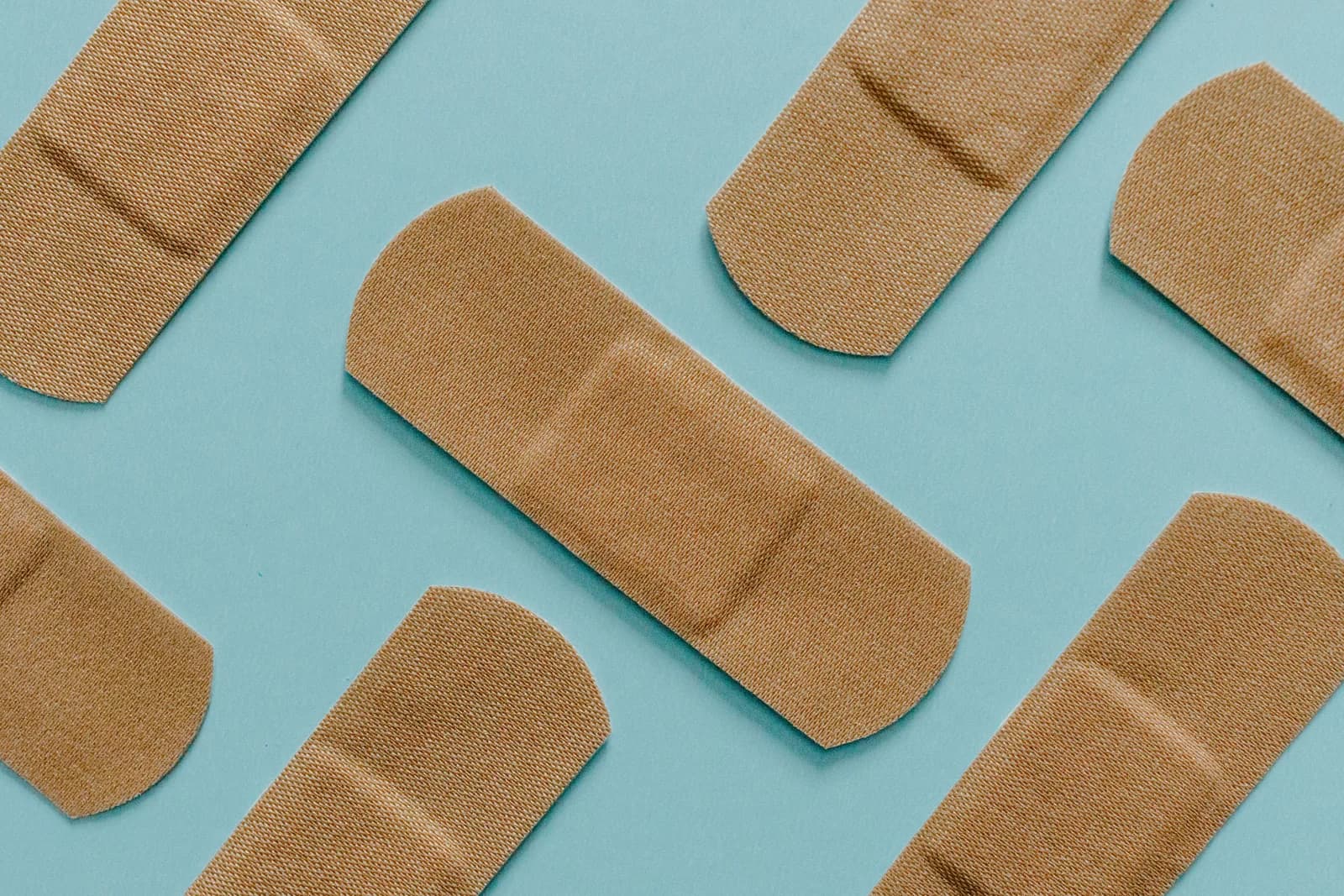 Adhesive dressings laid out on a blue surface